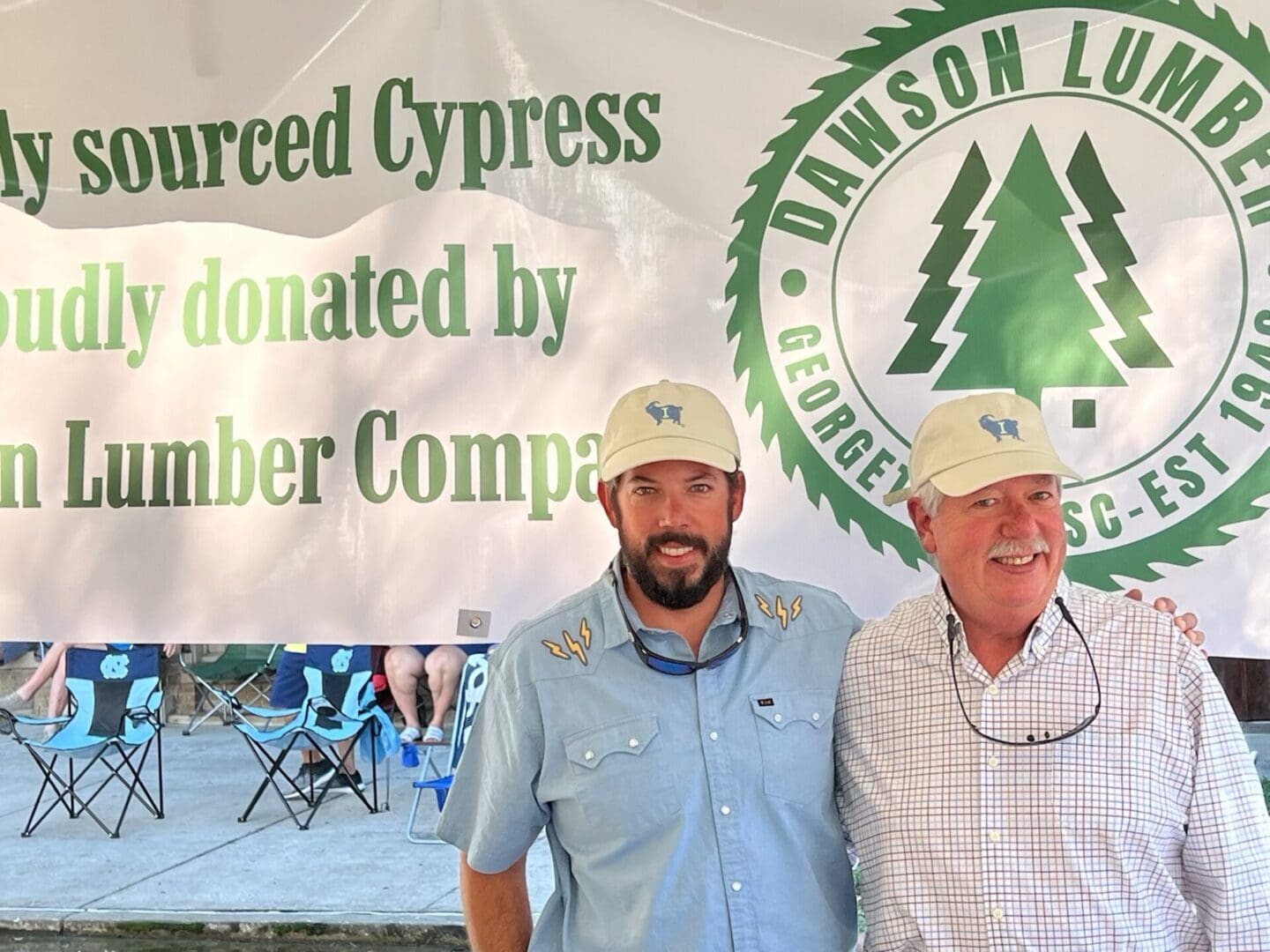 Two men wearing hats standing next to each other.